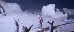 Witches dancing around a bonfire on a beach