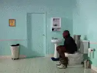 Man levitates off toilet in bathroom