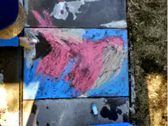 Chalk art covered by leaves and dirt