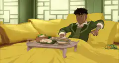Toph relaxing in bed with breakfast