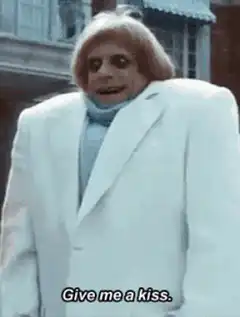 Creepy man in white suit says give me a kiss