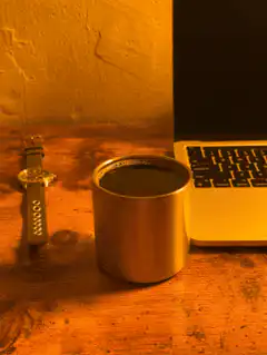 coffee cup on desk with laptop