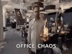 Man holding fire in office chaos