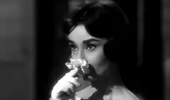 Audrey Hepburn smelling a flower
