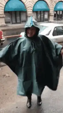 Woman in poncho dancing in rain