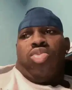 Man in blue durag crying