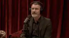 Man makes peace signs in podcast