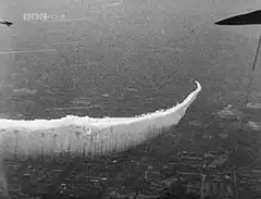 V2 rocket flying over city