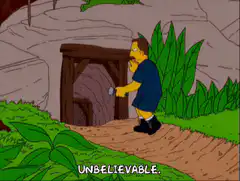 Homer shines flashlight into mine shaft