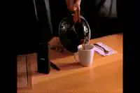 Person pouring coffee into a mug