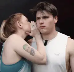 Woman whispers secret to man