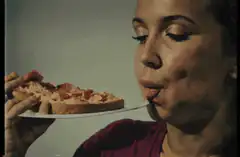 Woman eating pizza with a fork