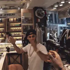 Man tries on necklace in jewelry store