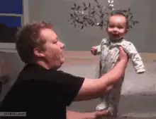 Baby dancing on man's hand