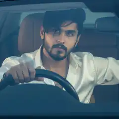 Man driving car in white shirt