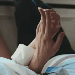 Two hands intertwining fingers