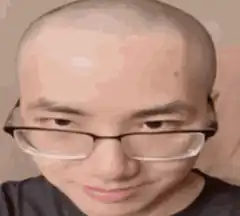 Bald man with glasses smirking