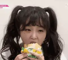 girl eating sandwich with pigtails