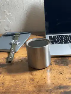 metal cup on wooden desk