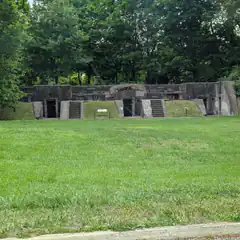 Concrete bunker in grassy field