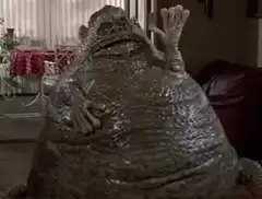 Giant frog waving in living room