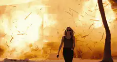 Woman walking away from explosion