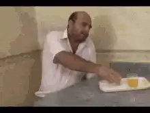 Man eats bread and drinks juice