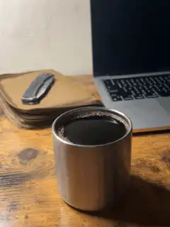 Coffee cup on desk with laptop