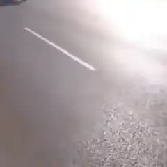 Car driving past military base and pointing at statue