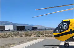 Yellow helicopter taking off