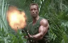 Arnold Schwarzenegger firing a gun in the jungle