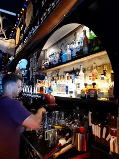 bartender pouring drink behind bar