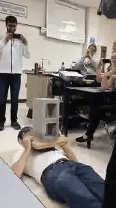 man breaks cinder block on chest