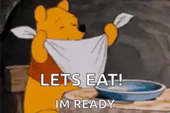 Winnie the Pooh puts on a bib ready to eat