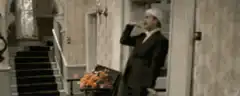 man in hat drinking in hallway