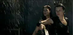 Two women in the rain with guns