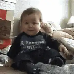 Baby laughs and falls over