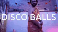 Man in toga dancing disco balls
