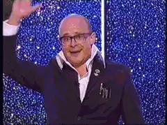 Dale Winton waves and holds flowers