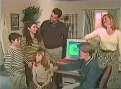 Family gathered around computer