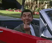 Mr Bean waving and giving the finger