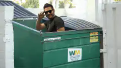 Man in dumpster waves and disappears