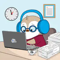Stressed penguin working at laptop