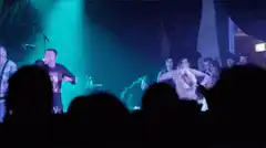 band performing on stage with green light