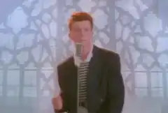 Rick Astley singing into a microphone
