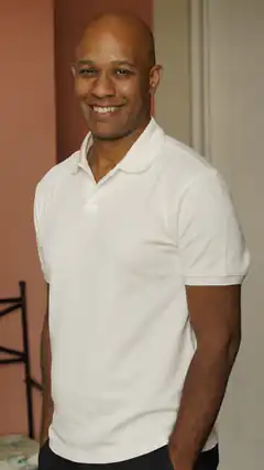 Happy bald man in white polo shirt