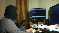 Hacker typing with banana