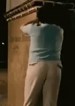 Woman leaning against wall at night