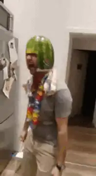 Man screaming with watermelon on head