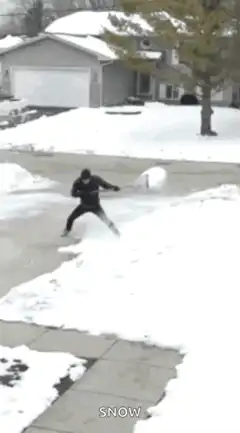 Man shoveling snow in driveway
